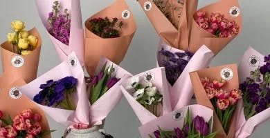 Spring flower bundles wrapped in decorative paper.
