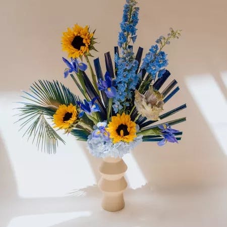 Flower arrangement of yellow and blue 