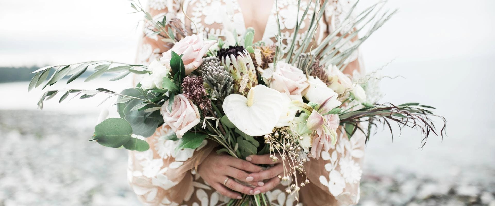 Bouquet and wedding ring. Bride in white dress