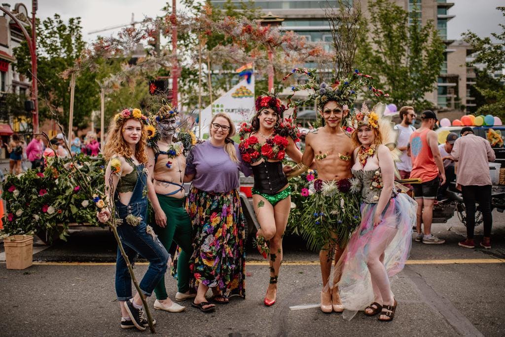Pride parade 2019 with drag performers wearing floral art.