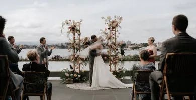 Bride and Groom kissing at the alter