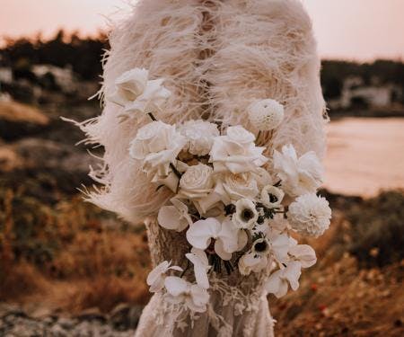 Bride with bouquet and fur wrap