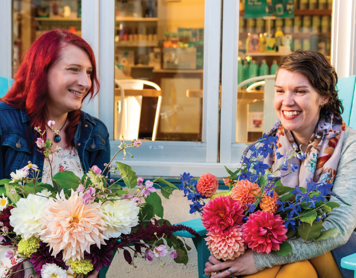 Amy and Marcy, a trans couple with dahlia bouquets